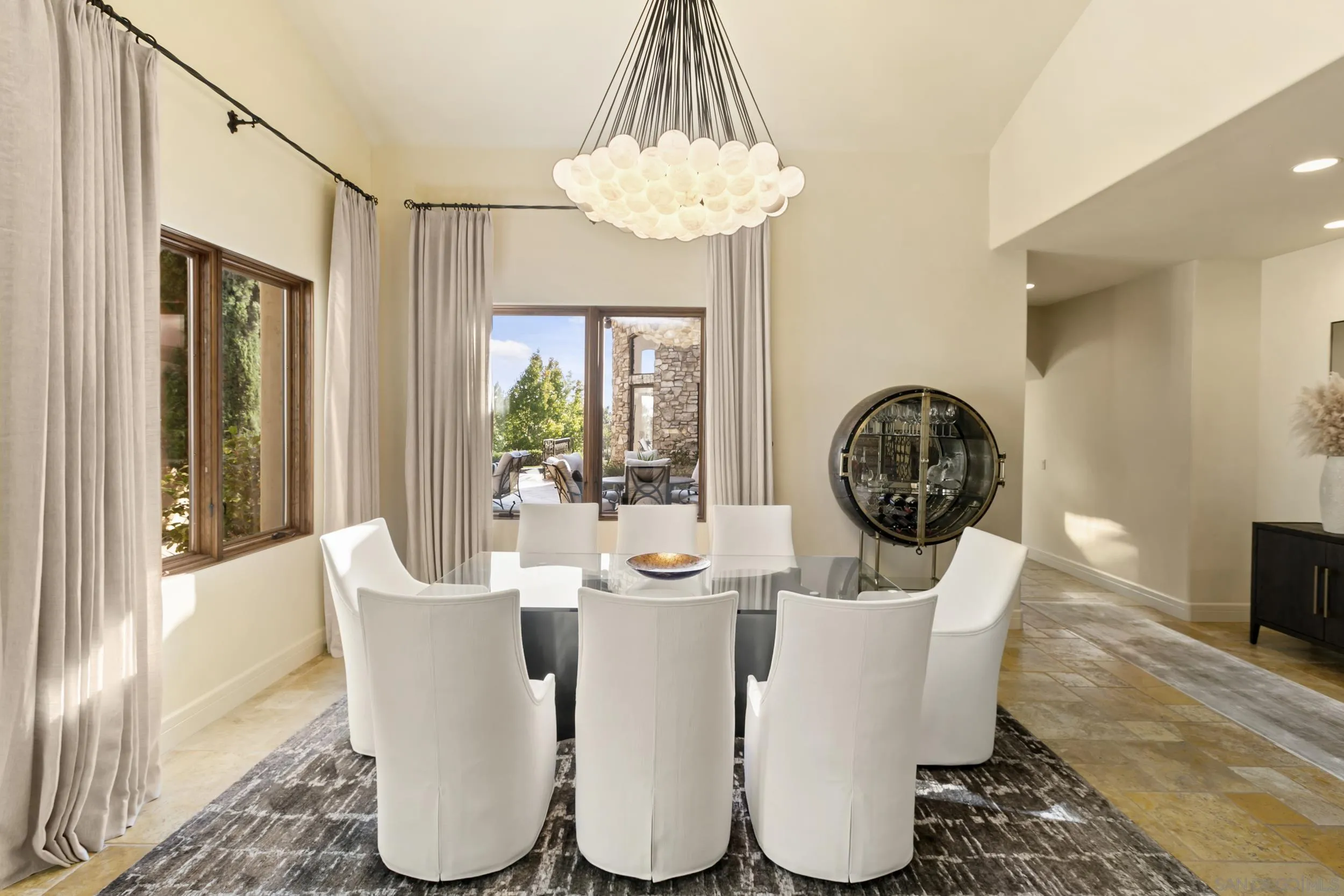 6089 Avenida Alteras Rancho Santa Fe, CA 92067 - Photo 9 of 23 a dining room with furniture a potted plant and a chandelier