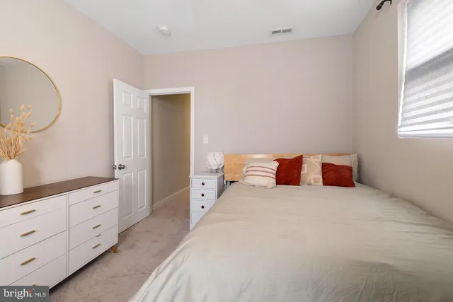 a bedroom with a bed and a dresser