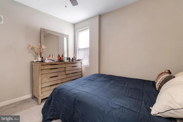 a bedroom with a bed and window