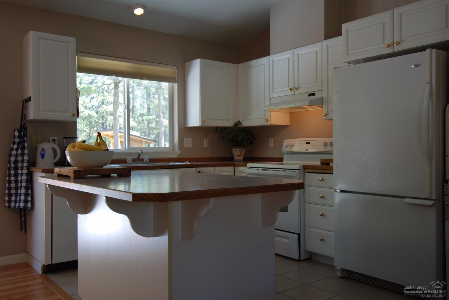 55726 Snow Goose Road Bend, OR 97707 - Photo 5 of 25 a kitchen with a sink appliances and cabinets