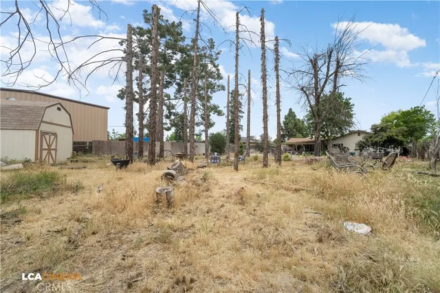 a view of yard covered with snow in front of house