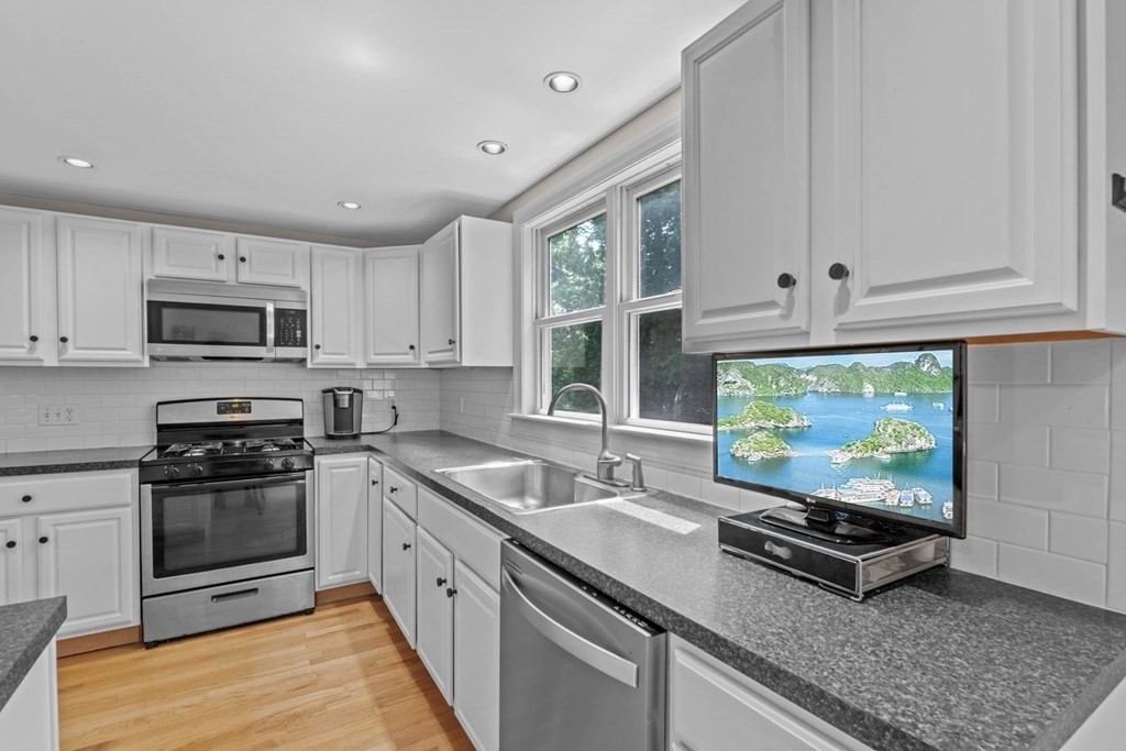 40 Pickwick Road Marblehead, MA 01945 - Photo 13 of 32 a kitchen with stainless steel appliances granite countertop a stove a sink and a microwave