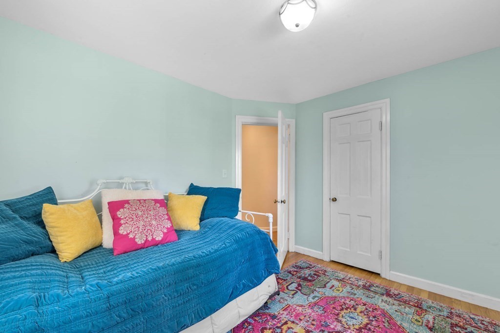 40 Pickwick Road Marblehead, MA 01945 - Photo 19 of 32 a bedroom with a bed and a lamp with wooden floor