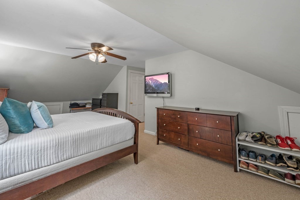 40 Pickwick Road Marblehead, MA 01945 - Photo 23 of 32 a bedroom with a bed and a chandelier