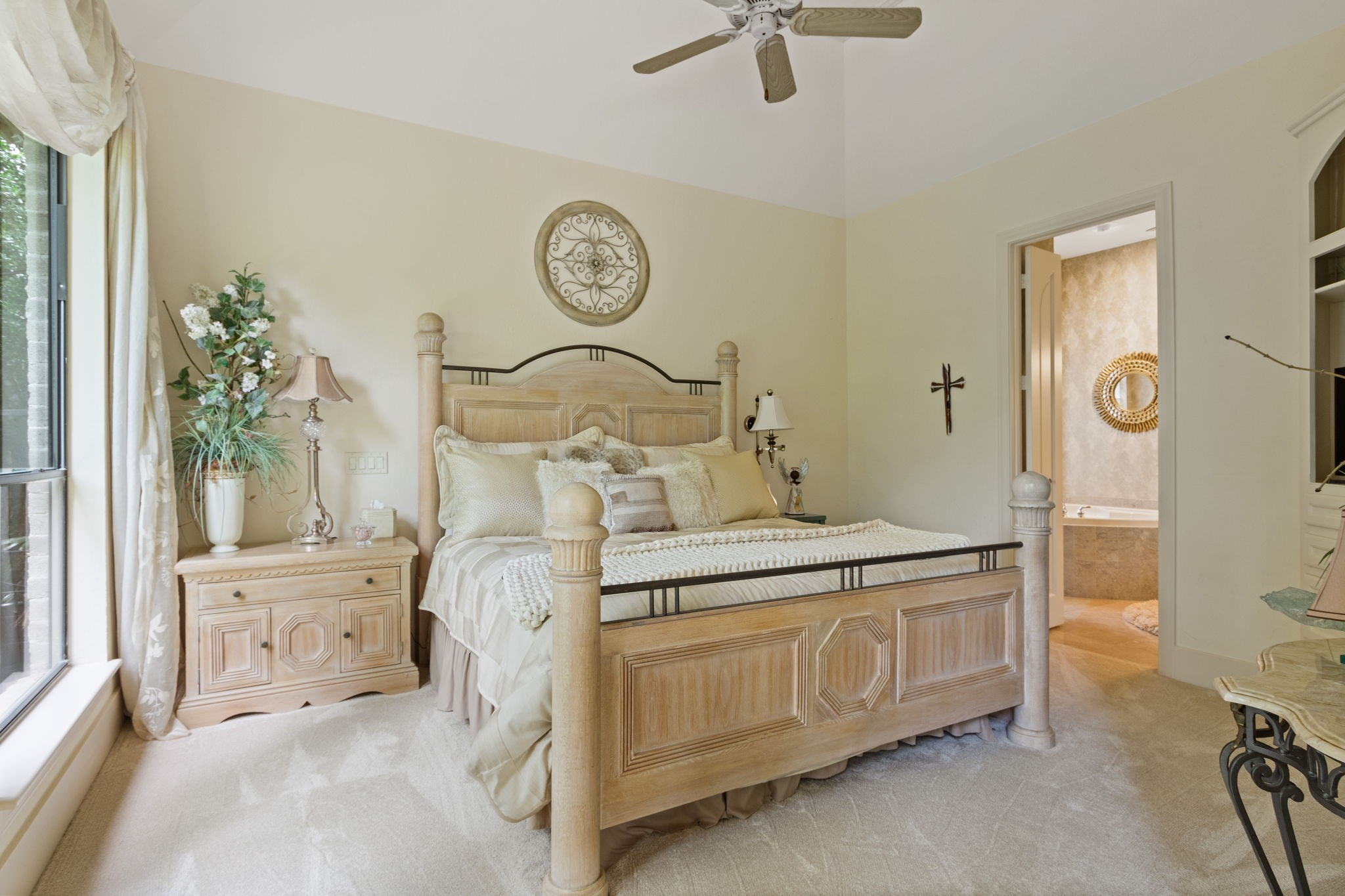 17511 Seidel Road Tomball, TX 77377 - Photo 33 of 49 a spacious bedroom with a bed and a chandelier