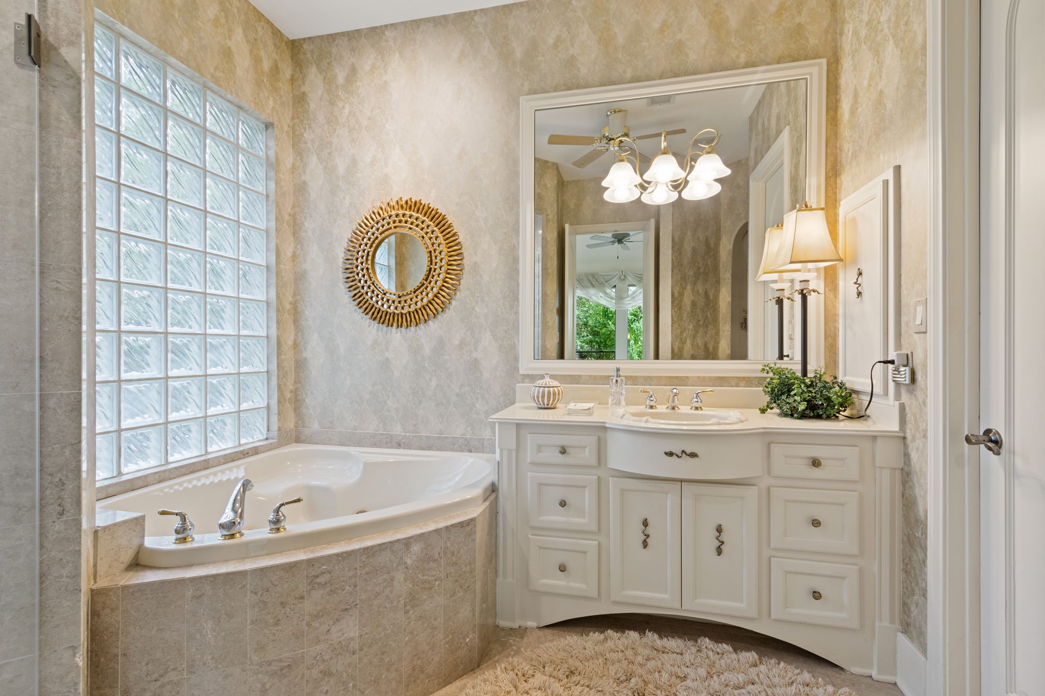 17511 Seidel Road Tomball, TX 77377 - Photo 34 of 49 a bathroom with a tub a sink and a large mirror