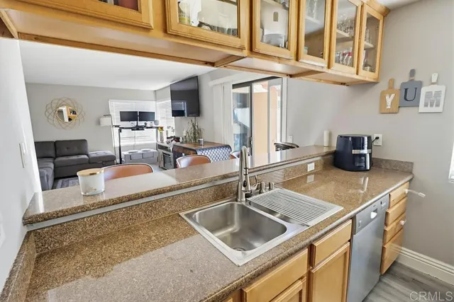 a kitchen with stainless steel appliances granite countertop a sink and a counter top space