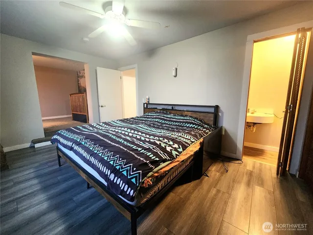 a bed sitting in a bedroom next to a window