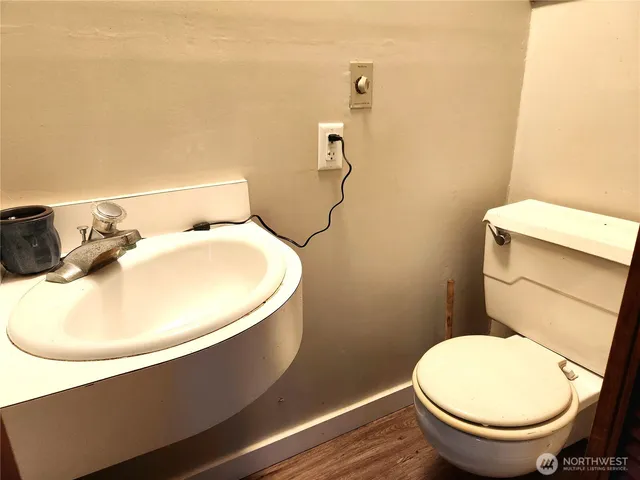 a bathroom with a toilet and a mirror