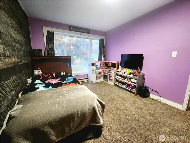 a bed room with a bed and a flat screen tv