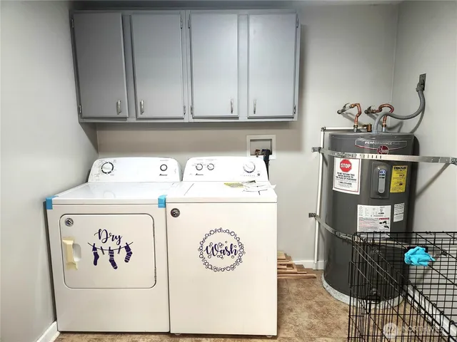a utility room with dryer washer and storage