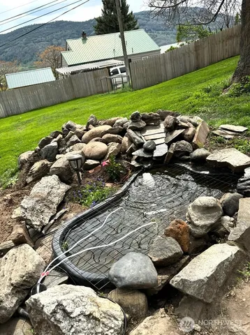 a view of a backyard with a garden and trees