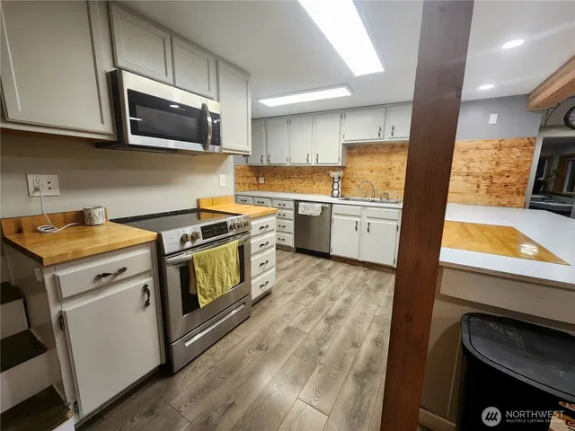 a kitchen with a sink stove and microwave