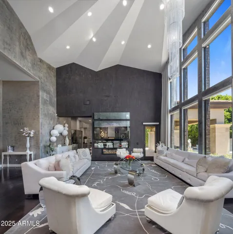 a living room with fireplace furniture and a large window