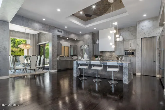 a kitchen with a table chairs refrigerator and microwave