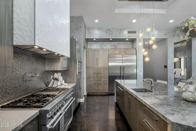 a living room with furniture a chandelier a large window and a chandelier