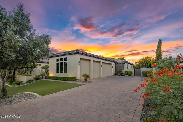a view of a house with a yard and potted plants