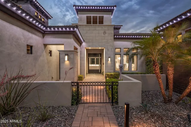 a backyard of a house with table and chairs