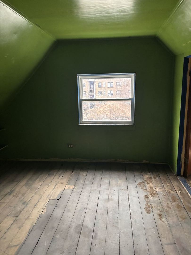 2469 East 74th Street Chicago, IL 60649 - Photo 17 of 24 a view of an empty room with a window