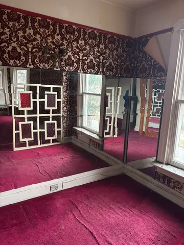 a view of an empty room with windows