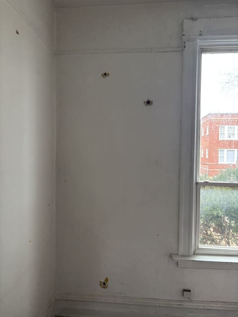 2469 East 74th Street Chicago, IL 60649 - Photo 24 of 24 a room with a window and a ceiling fan