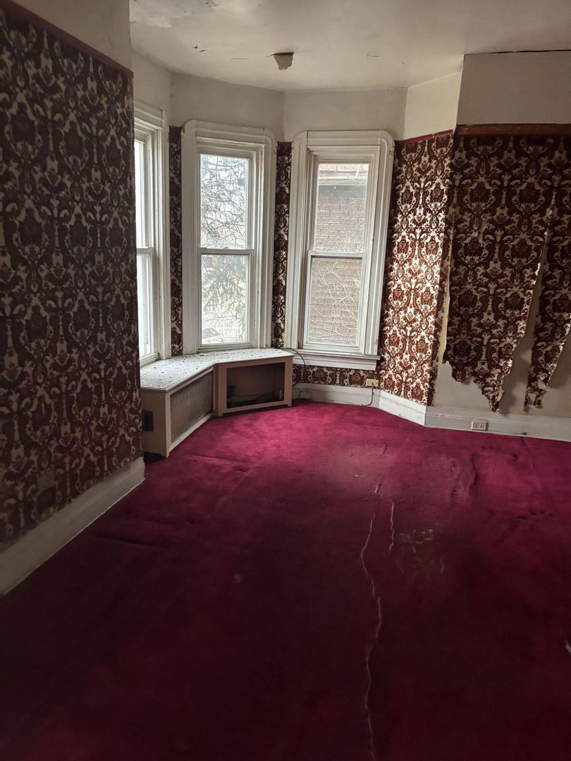 2469 East 74th Street Chicago, IL 60649 - Photo 3 of 24 en empty room with windows and brick walls