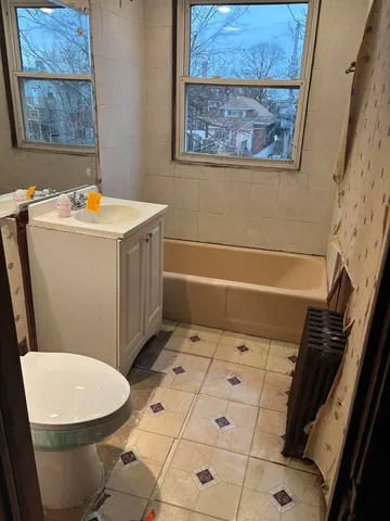 a bathroom with a toilet a sink and bath tub