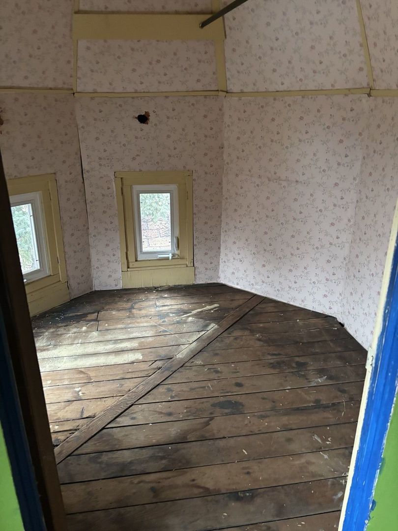 2469 East 74th Street Chicago, IL 60649 - Photo 8 of 24 a view of empty room with window and fireplace