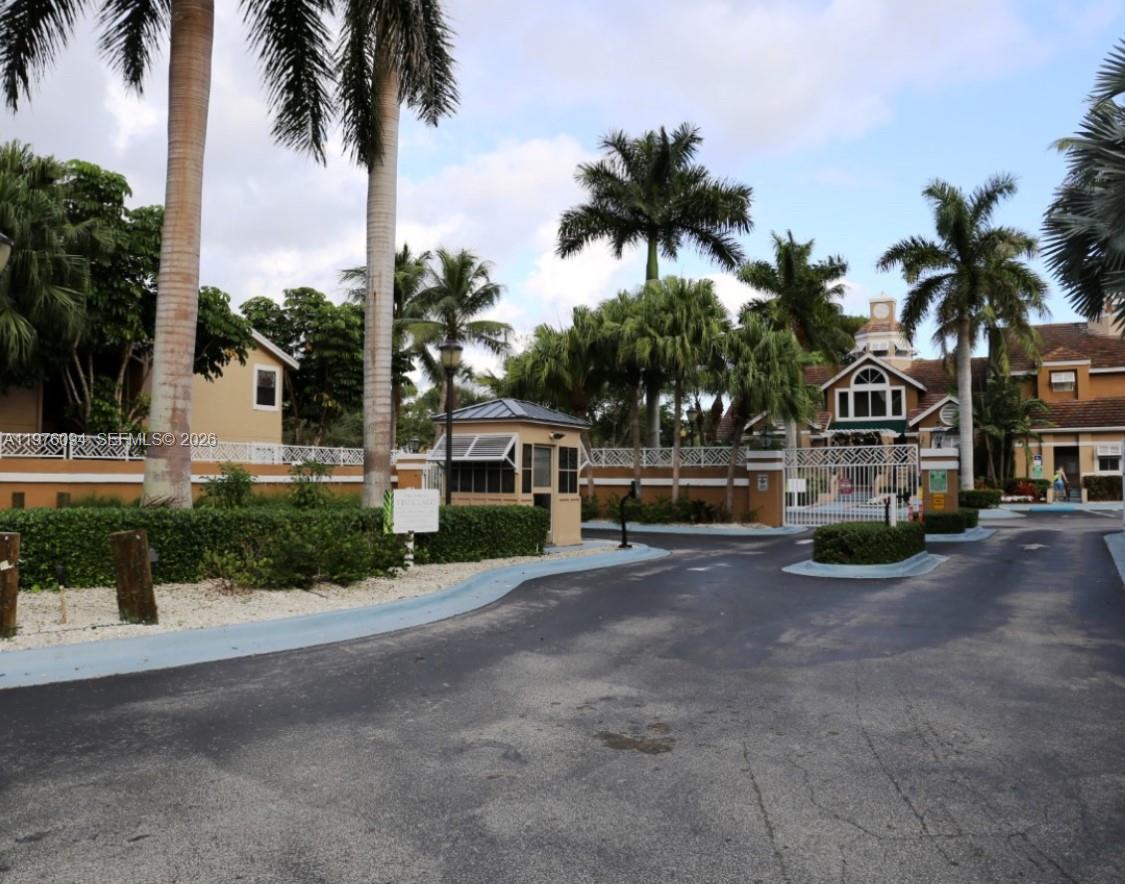 15640 Southwest 106th Lane, Unit 903 Miami, FL 33196 - Photo 2 of 8 a front view of a house with palm trees