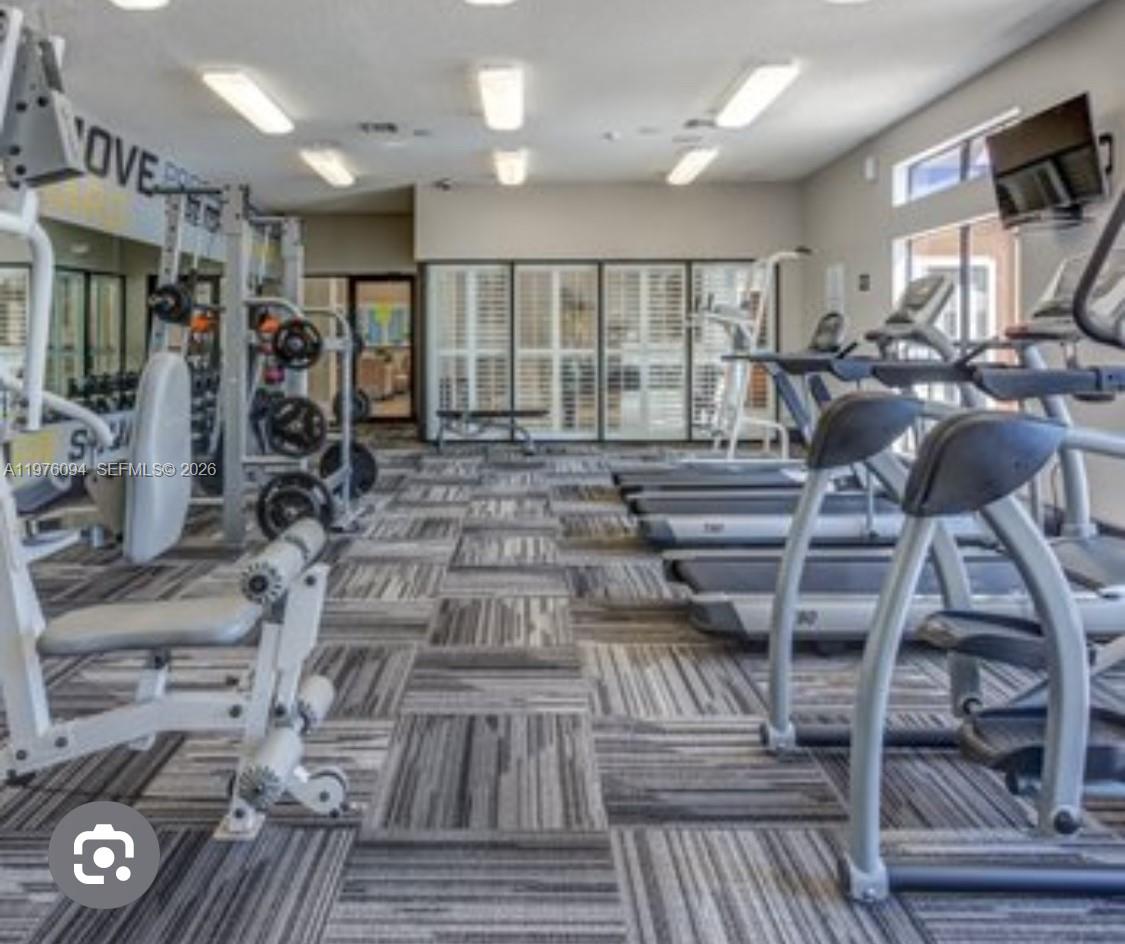 15640 Southwest 106th Lane, Unit 903 Miami, FL 33196 - Photo 4 of 8 a view of a room with gym equipment