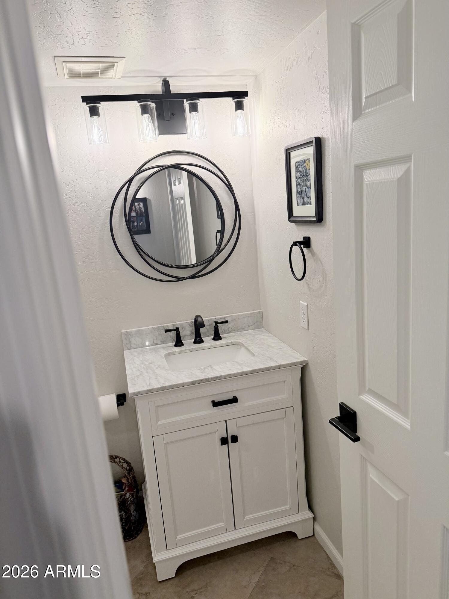 3426 East Clark Road Phoenix, AZ 85050 - Photo 8 of 48 a bathroom with a sink and a washer