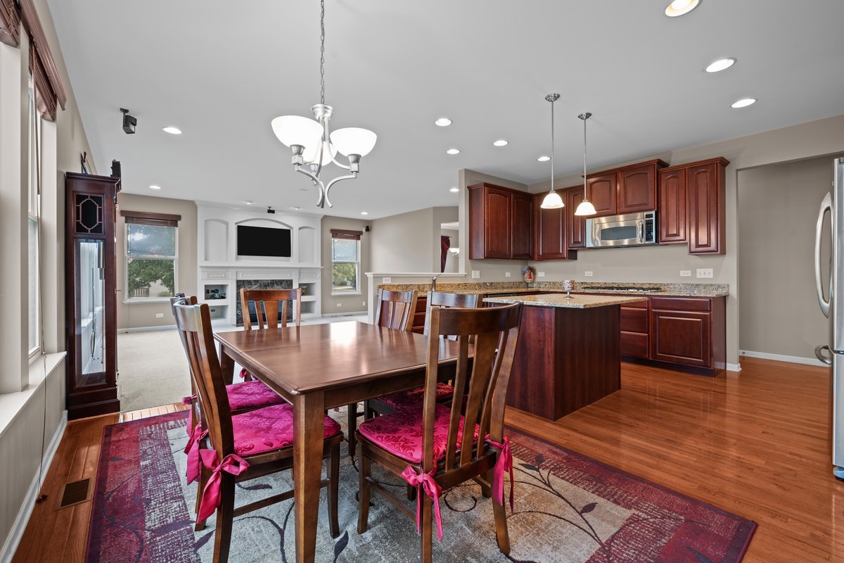 312 Monument Road Elgin, IL 60124 - Photo 12 of 44 a view of a dining room with furniture and wooden floor