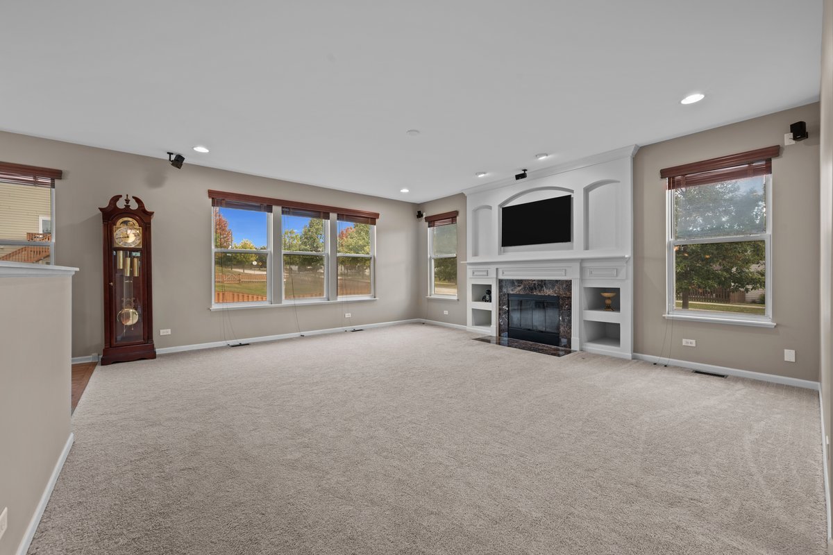 312 Monument Road Elgin, IL 60124 - Photo 14 of 44 an empty room with furniture and a fireplace
