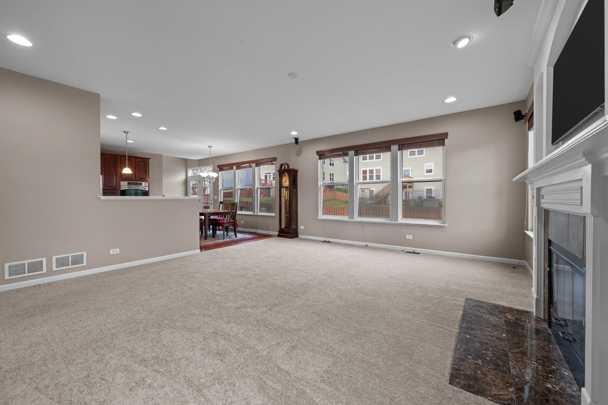 312 Monument Road Elgin, IL 60124 - Photo 15 of 44 a view of an empty room with a window and fireplace