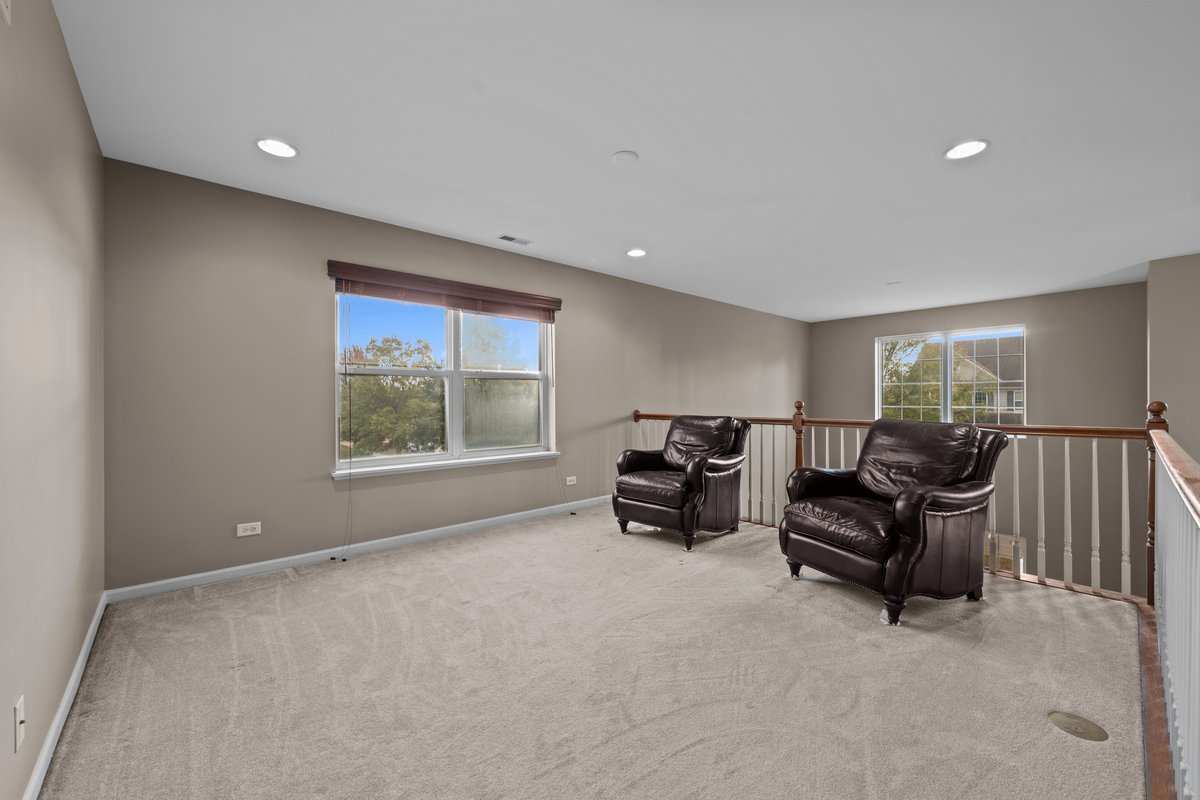 312 Monument Road Elgin, IL 60124 - Photo 20 of 44 a living room with furniture and large windows