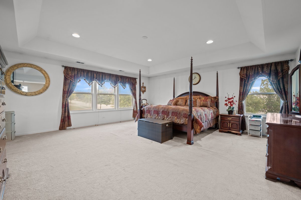 312 Monument Road Elgin, IL 60124 - Photo 21 of 44 a spacious bedroom with a bed and dresser
