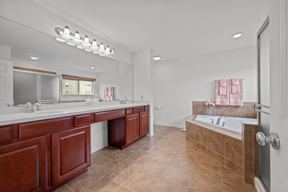 312 Monument Road Elgin, IL 60124 - Photo 22 of 44 a large bathroom with a large tub and sink