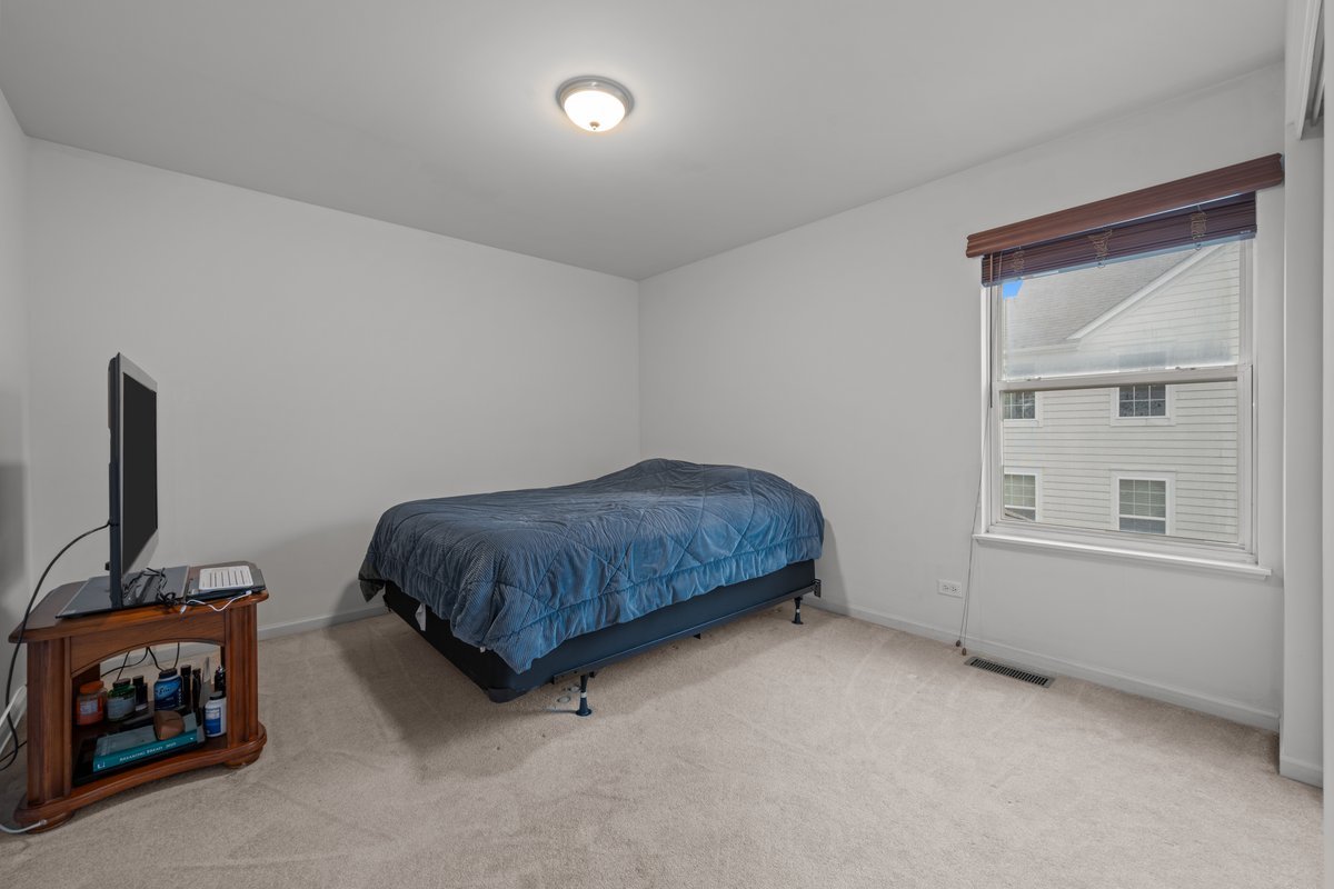 312 Monument Road Elgin, IL 60124 - Photo 25 of 44 a bedroom with a bed and a window