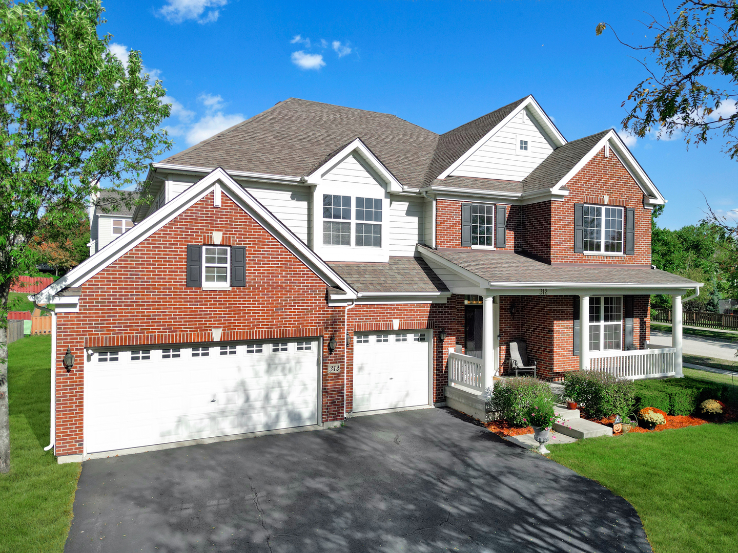 312 Monument Road Elgin, IL 60124 - Photo 37 of 44 a front view of a house with a yard and garage