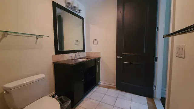 a bathroom with a sink a toilet and mirror