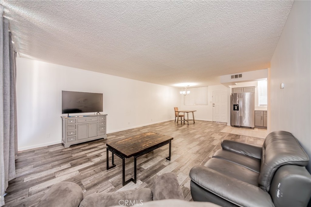 6979 Palm Court, Unit 319F Riverside, CA 92506 - Photo 11 of 44 a living room with furniture and a flat screen tv