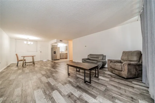a view of a livingroom with wooden floor and a window