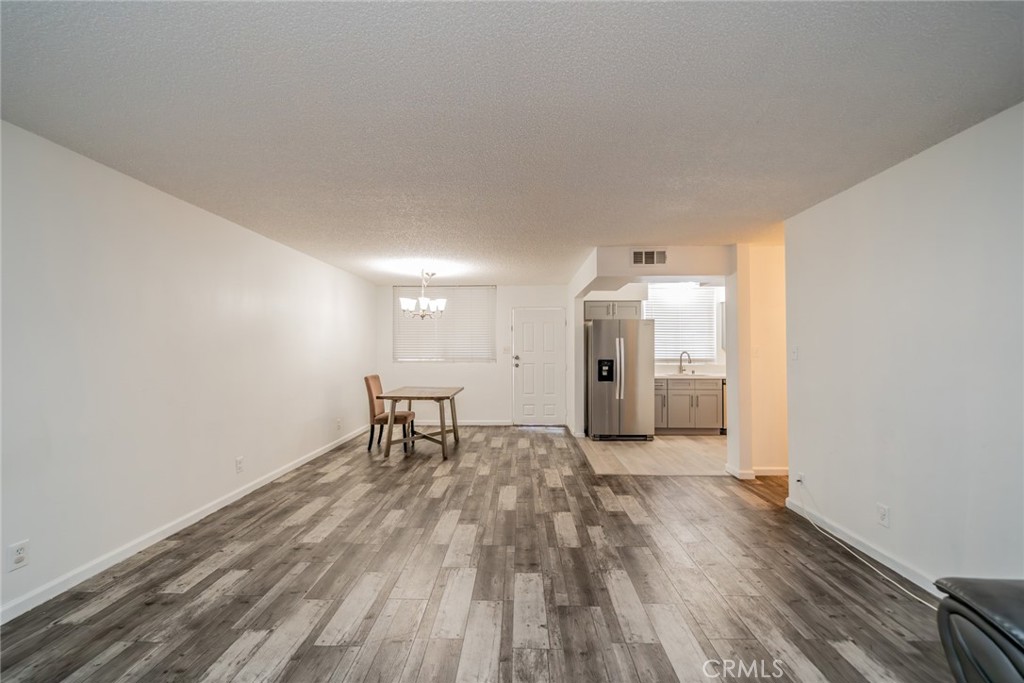 6979 Palm Court, Unit 319F Riverside, CA 92506 - Photo 13 of 44 a view of a livingroom with wooden floor and a window