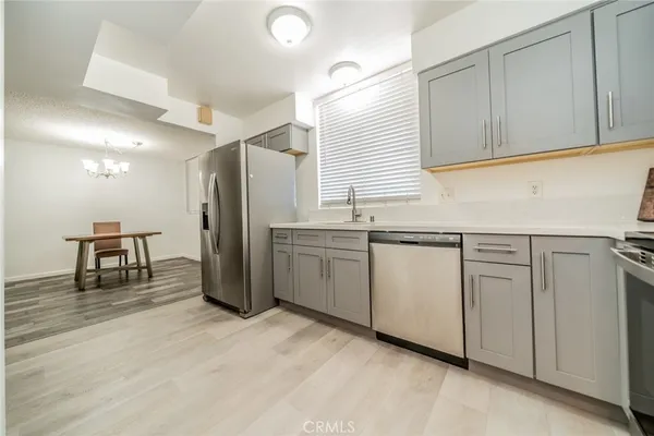 a kitchen with stainless steel appliances granite countertop a stove and a sink
