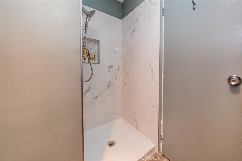 6979 Palm Court, Unit 319F Riverside, CA 92506 - Photo 20 of 44 a bathroom with a glass shower door