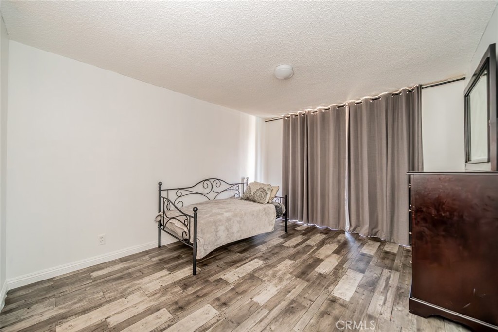 6979 Palm Court, Unit 319F Riverside, CA 92506 - Photo 24 of 44 a bedroom with a bed and a window