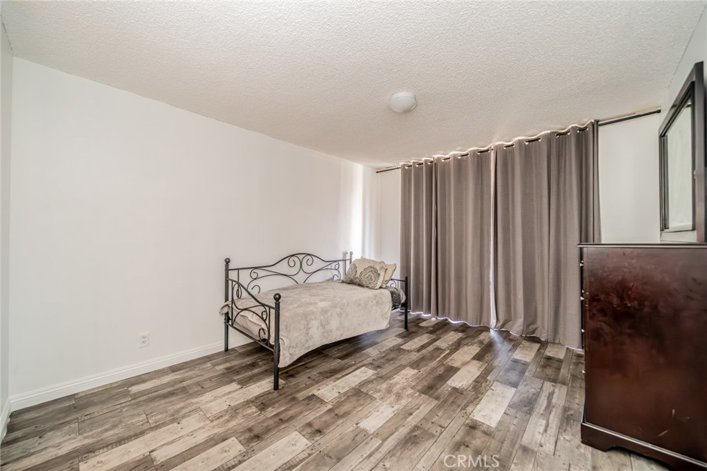 6979 Palm Court, Unit 319F Riverside, CA 92506 - Photo 24 of 44 a bedroom with a bed and a window