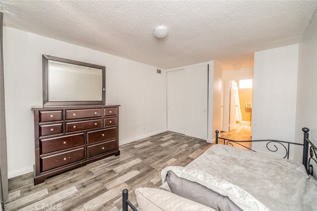 6979 Palm Court, Unit 319F Riverside, CA 92506 - Photo 25 of 44 a bedroom with a bed and a dresser
