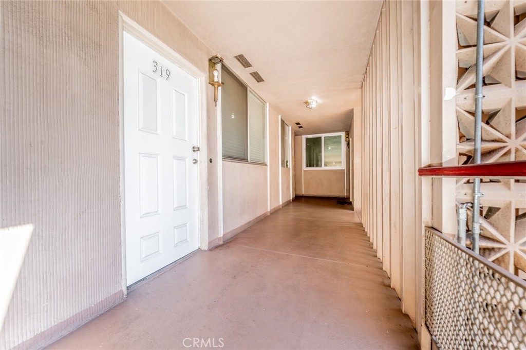6979 Palm Court, Unit 319F Riverside, CA 92506 - Photo 5 of 44 a view of a hallway with wooden floor and windows
