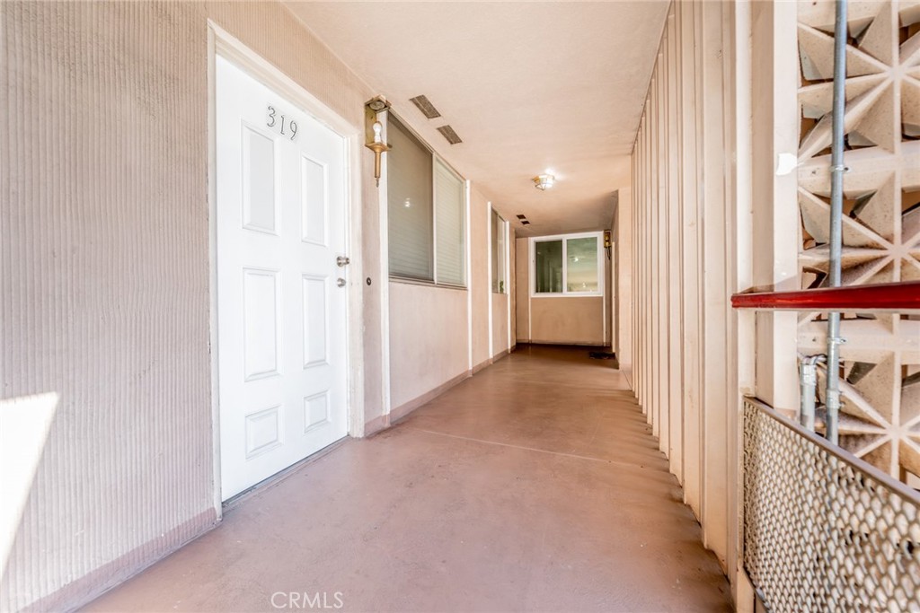 6979 Palm Court, Unit 319F Riverside, CA 92506 - Photo 5 of 44 a view of a hallway with wooden floor and windows
